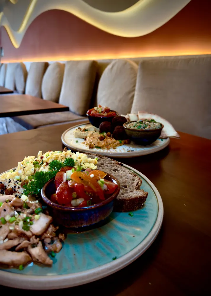 Intérieur Amaya — banquette beige et mezze méditerranéen